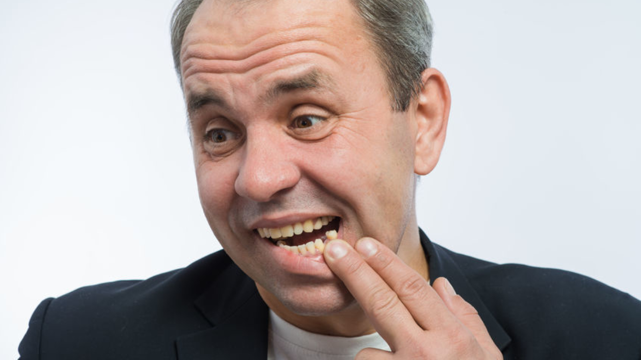 part of a man's face with a smiling toothless