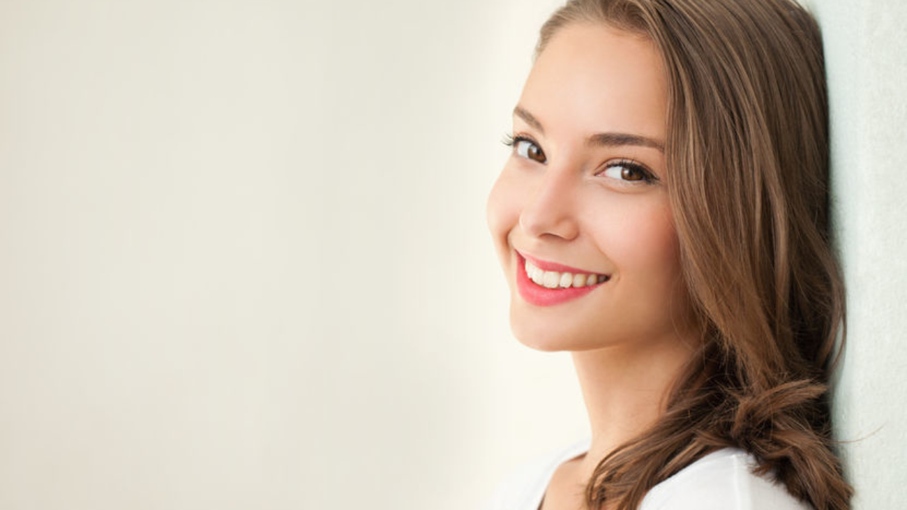 Close portrait of a tanned brunette summer beauty.