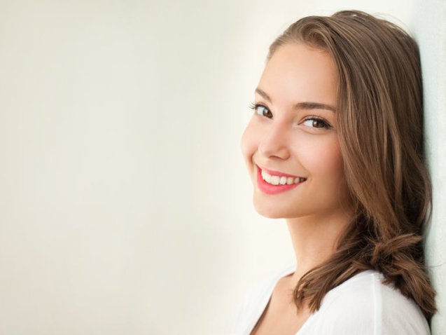 Close portrait of a tanned brunette summer beauty.